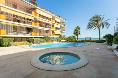a swimming pool in front of a building at Canela Homes COSTA CALMA in Castelldefels