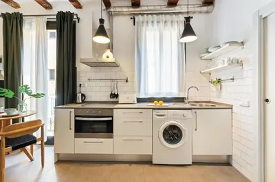 a kitchen with a washing machine and a sink at Lodging Apartments Almirall Beach 41 in Barcelona