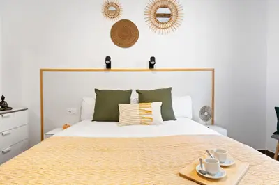 a bedroom with a large white bed with a tray on it at Lodging Apartments Almirall Beach 41 in Barcelona