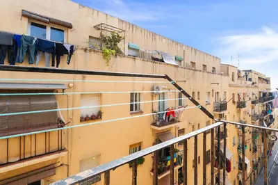 an apartment building with clothes hanging on a balcony at Lodging Apartments Almirall Beach 51 in Barcelona