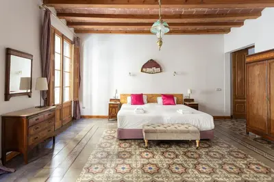 a bedroom with a large bed and a dresser at Canela Homes BARCELONA JOVELLANOS in Barcelona