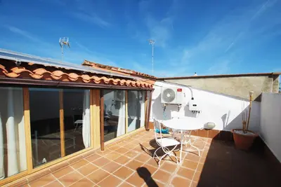 a balcony with a table and chairs on a house at Cami Ral in Premiá de Mar