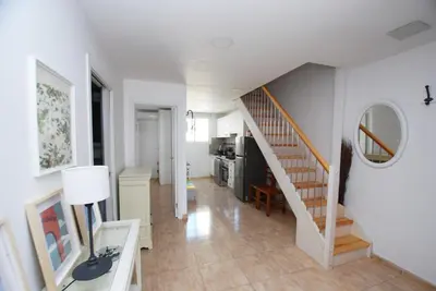 a room with a staircase and a living room at Cami Ral in Premiá de Mar