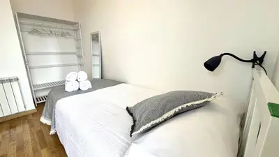 a bedroom with a bed with two slippers on it at APARTAMENTO CON TERRAZA BY PRESTIGI in Terrassa