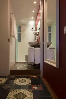 a bedroom with a bed and a view of a balcony at The Collection Barcelona - Paseo de Gracia Catalan 4BD with private Terrace in Barcelona