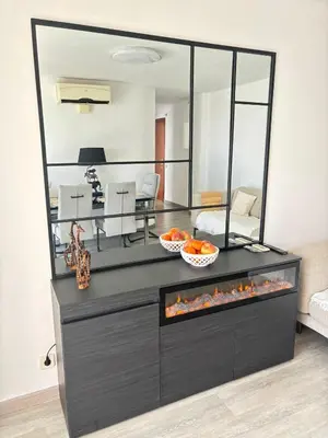 a living room with a large mirror on a dresser at Apartamento Forum in Barcelona