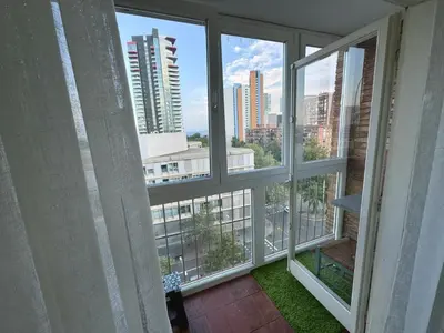 a room with windows with a view of a city at Apartamento Forum in Barcelona