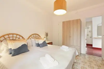 a bedroom with a large white bed with two pillows at Sagrada Familia Vl by Enjoy Apartments in Barcelona