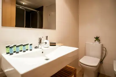 a bathroom with a sink and a toilet at Feelathome Mozart Apartments in Barcelona