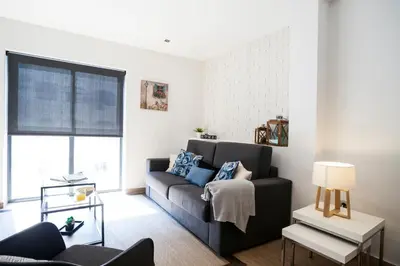 a living room with a couch and a table at Feelathome Mozart Apartments in Barcelona