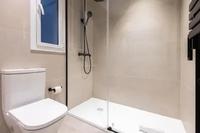 a shower with a toilet and a glass door at Stay U-nique Apartments Balmes II in Barcelona