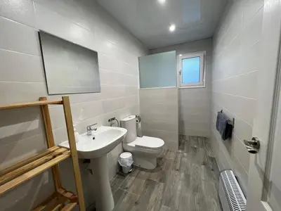 a white bathroom with a toilet and a sink at VILLA MasÍa CAL TONI in Pineda de Mar