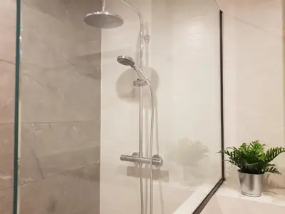 a shower with a glass door in a bathroom at Pis clar i espaiós in Manresa