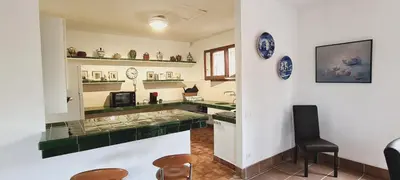 a large blue swimming pool with an umbrella at Villa Apartment with Pool and Amazing Views! in Arenys de Mar