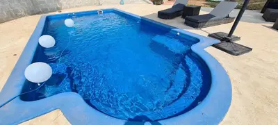 a wooden bench sitting outside of a house at Villa Apartment with Pool and Amazing Views! in Arenys de Mar