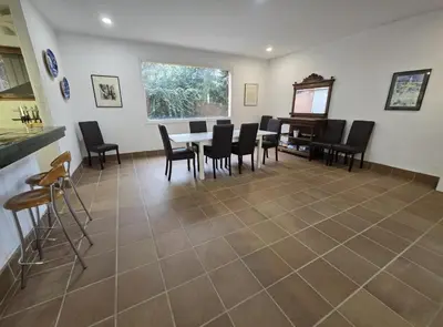 a dining room with a table and chairs and a piano at Villa Apartment with Pool and Amazing Views! in Arenys de Mar