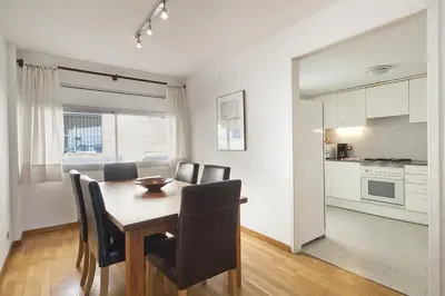 a kitchen and dining room with a table and chairs at Vila Olimpica Skyline in Barcelona