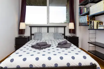 a bedroom with a bed with two pillows on it at Vila Olimpica Skyline in Barcelona