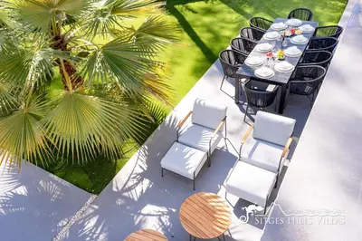 a black table with chairs and plates of food on it at Stunning Villa Angeles with Private Pool and AC close to Sitges in Olivella