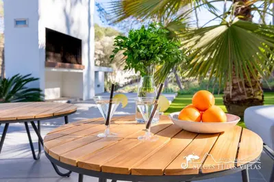 two beds in a white bedroom with a window at Stunning Villa Angeles with Private Pool and AC close to Sitges in Olivella
