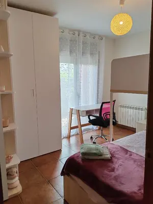 a bedroom with a bed and a desk and a table at Casa Santa Creu - Private family villa in nature in Piera