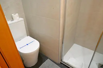 a bathroom with a white sink and a mirror at Homenfun Barcelona Eixample ll in Barcelona