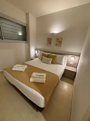 a bedroom with a large bed with two towels on it at Stay Unique Apartments Pau Claris con piscina in Barcelona