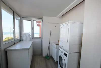a laundry room with a washing machine and a window at Picasso Street in Vilassar de Mar