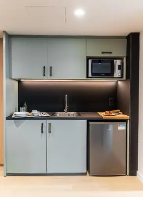 a kitchen with a sink and a microwave at Atenea Living in Mataró