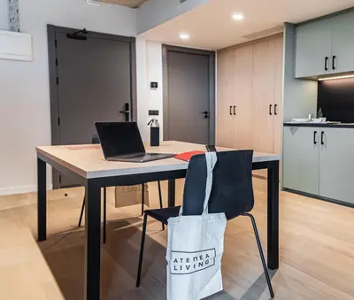 a kitchen with a table with a laptop on it at Atenea Living in Mataró