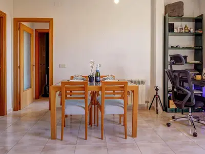 a dining room with a wooden table and chairs at Castell Apartment by Hello Homes Sitges in Sitges
