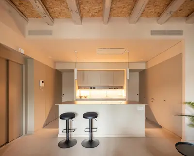 a walk in closet with white drawers and clothes at Casa Badajoz in Barcelona