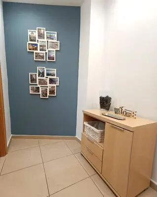 a room with a blue wall with pictures on the wall at Apartamento Gerimar - Gelida/Bcn in Gélida