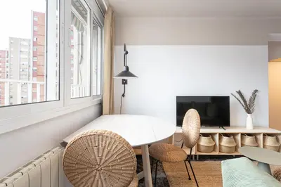 a living room with a table and chairs and a tv at 3 Bdr Apt In Cornella 5 Mins Form The Metro in Cornellà de Llobregat