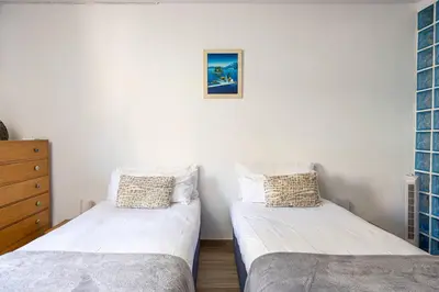 a bedroom with two beds and a dresser at House 5 Mins From Montgat Beach in Montgat
