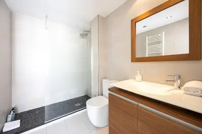 a bathroom with a sink and a toilet and a mirror at House 5 Mins From Montgat Beach in Montgat