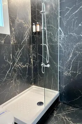 a bathroom with a shower with a glass door at Aldara Sitges in Sitges