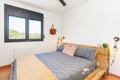 a dining room with a table and chairs and a large window at Villa Serranita - Stylish Holiday Home with Views and Air Conditioning 15 mins to Sitges in Olivella