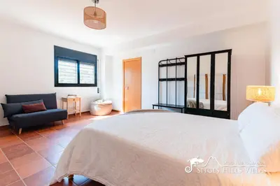 a hallway with a black console table and a mirror at Villa Serranita - Stylish Holiday Home with Views and Air Conditioning 15 mins to Sitges in Olivella