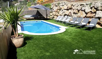a swimming pool with chairs and a plant in a yard at Villa Serranita - Stylish Holiday Home with Views and Air Conditioning 15 mins to Sitges in Olivella