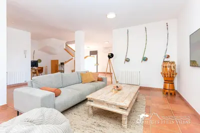 a bedroom with a bed and a tiled floor at Villa Serranita - Stylish Holiday Home with Views and Air Conditioning 15 mins to Sitges in Olivella