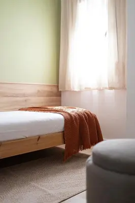 a bedroom with a bed and a window at Lovely Attic With Terrace in Hospitalet de Llobregat