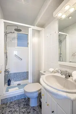 a white bathroom with a toilet and a sink at 2 Bdr Apt In Cornella 5 Mins Form The Metro in Cornellà de Llobregat