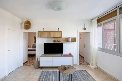 a living room with a flat screen tv on a table at 2 Bdr Apt In Cornella 5 Mins Form The Metro in Cornellà de Llobregat