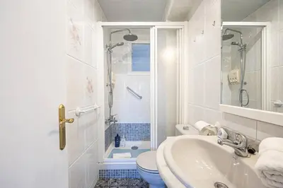 a white bathroom with a toilet and a sink at 2 Bdr Apt In Cornella 5 Mins Form The Metro in Cornellà de Llobregat