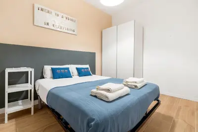 a bedroom with a large bed with towels on it at Big Central Barcelona Flat - 4BR for 7 in Barcelona