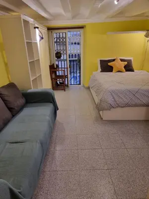a living room with two beds and a couch at Cozy Apartment downtown BCN, AC, 30 nigths min in Barcelona