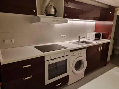 a kitchen with a sink and a washing machine at Cozy Apartment downtown BCN, AC, 30 nigths min in Barcelona