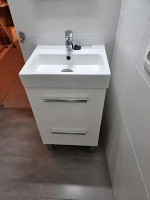 a bathroom with a white sink in a room at Cozy Apartment downtown BCN, AC, 30 nigths min in Barcelona
