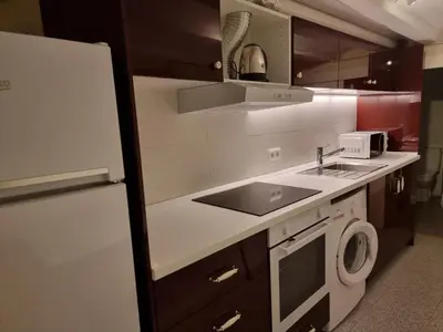 a kitchen with a sink and a washing machine at Cozy Apartment downtown BCN, AC, 30 nigths min in Barcelona